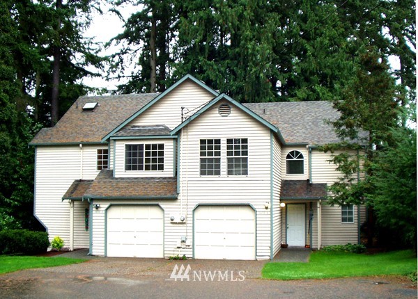 9406 232nd Street Southwest Edmonds, WA 98020 - Photo 1 of 1 a front view of a house with a garden and trees