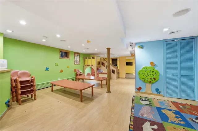 a room with furniture pool table and windows