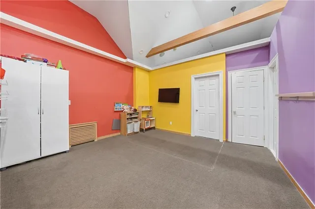 an empty room with wooden floor and furniture