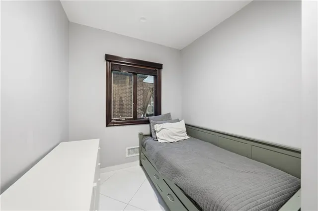 a bedroom with a bed and window