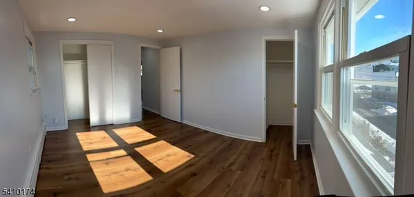 a view of an empty room and glass door