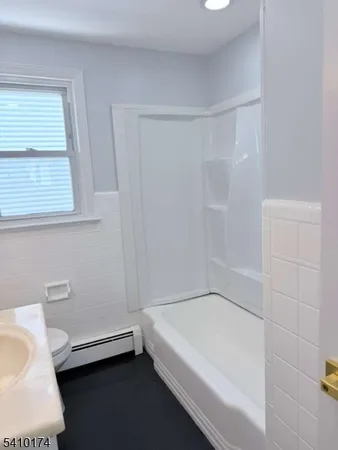 a bathroom with a bathtub and a toilet
