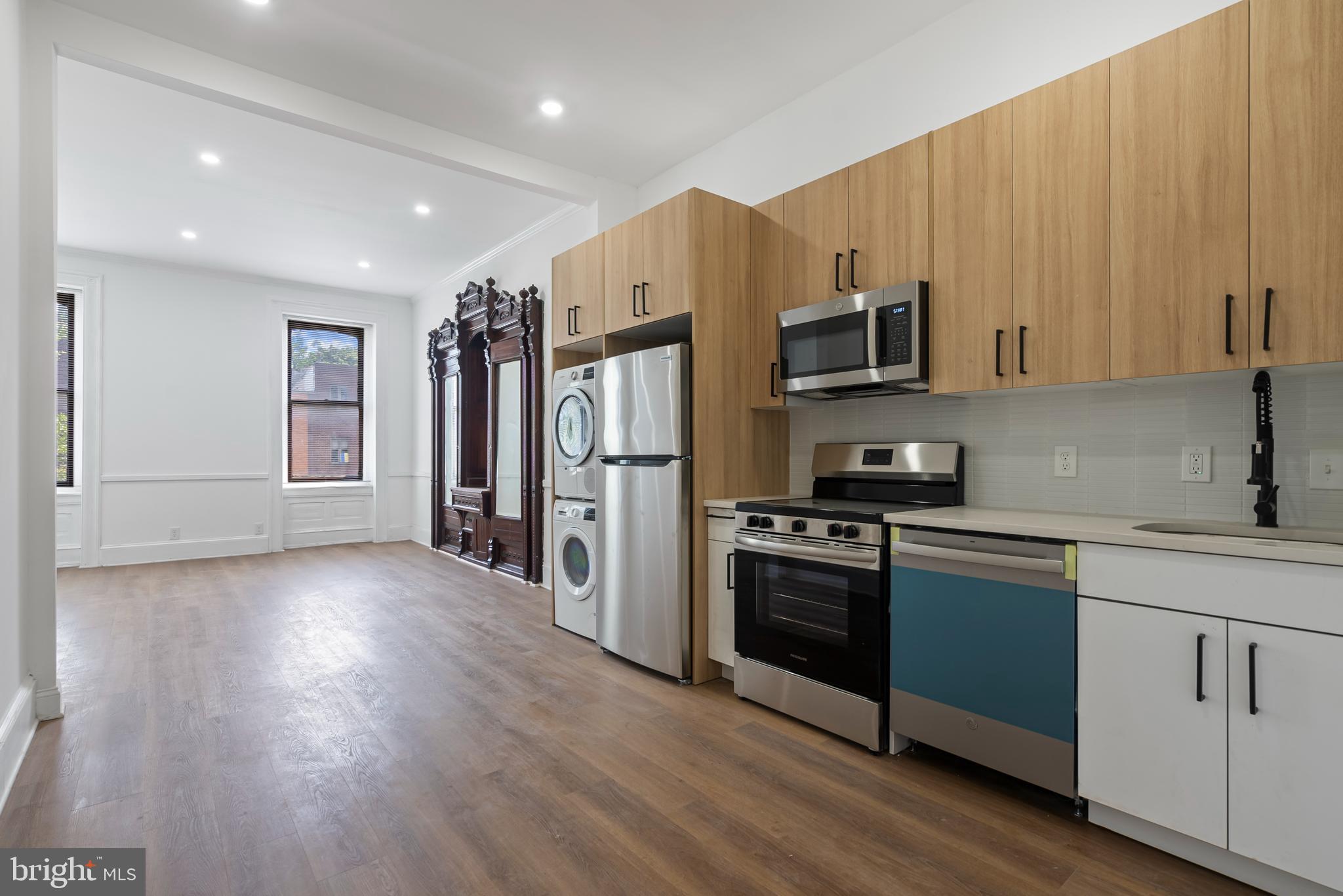 1618 South Broad Street Philadelphia, PA 19145 - Photo 12 of 27 a kitchen with stainless steel appliances granite countertop a refrigerator microwave and stove