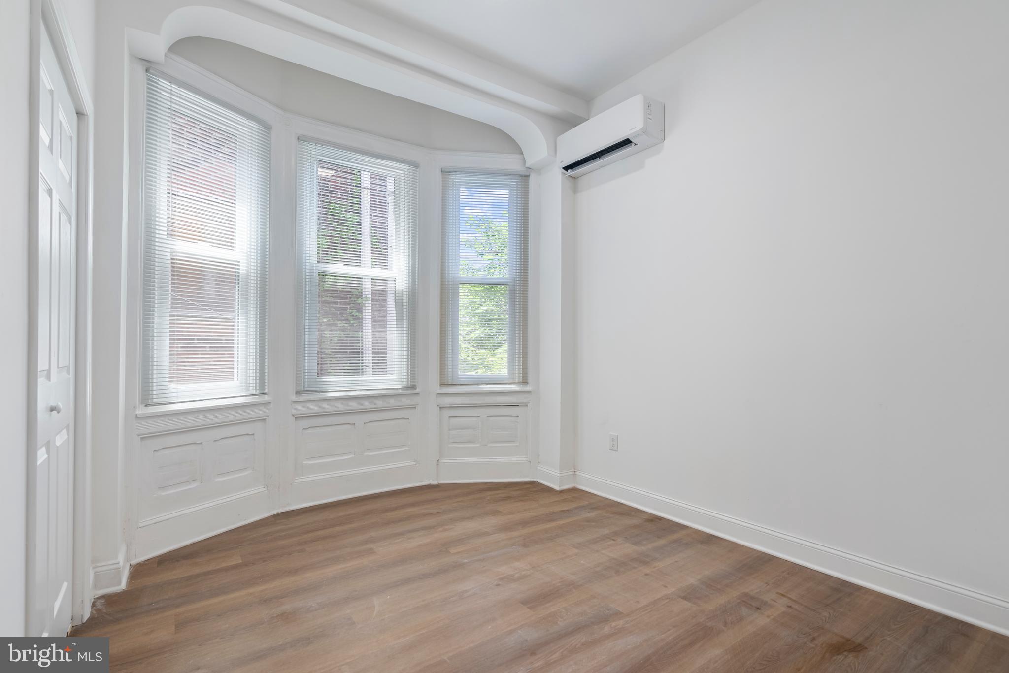 1618 South Broad Street Philadelphia, PA 19145 - Photo 14 of 27 an empty room with wooden floor and windows