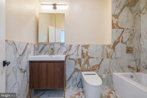 a view of an empty room with wooden floor and windows