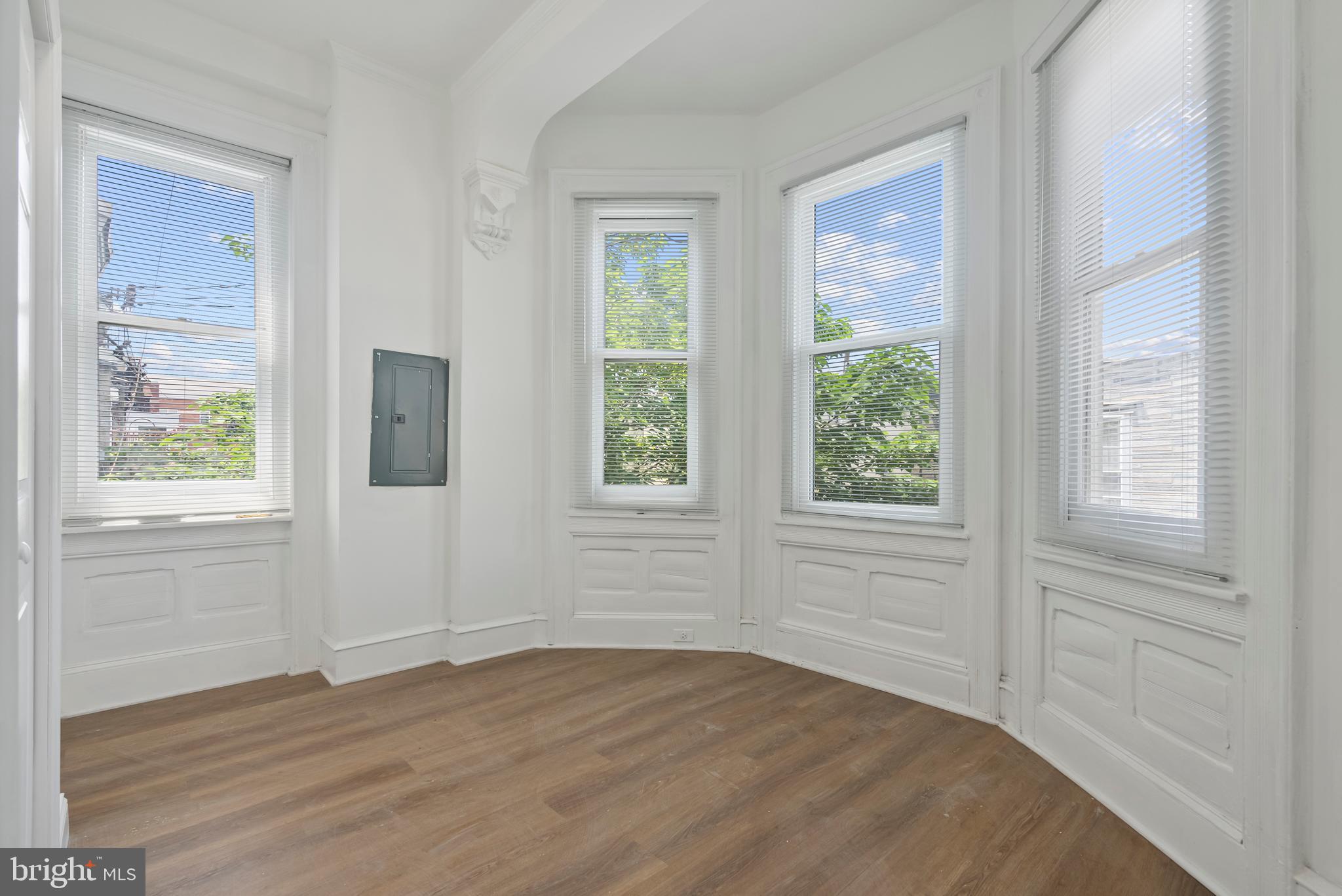 1618 South Broad Street Philadelphia, PA 19145 - Photo 16 of 27 a view of an empty room with wooden floor and windows