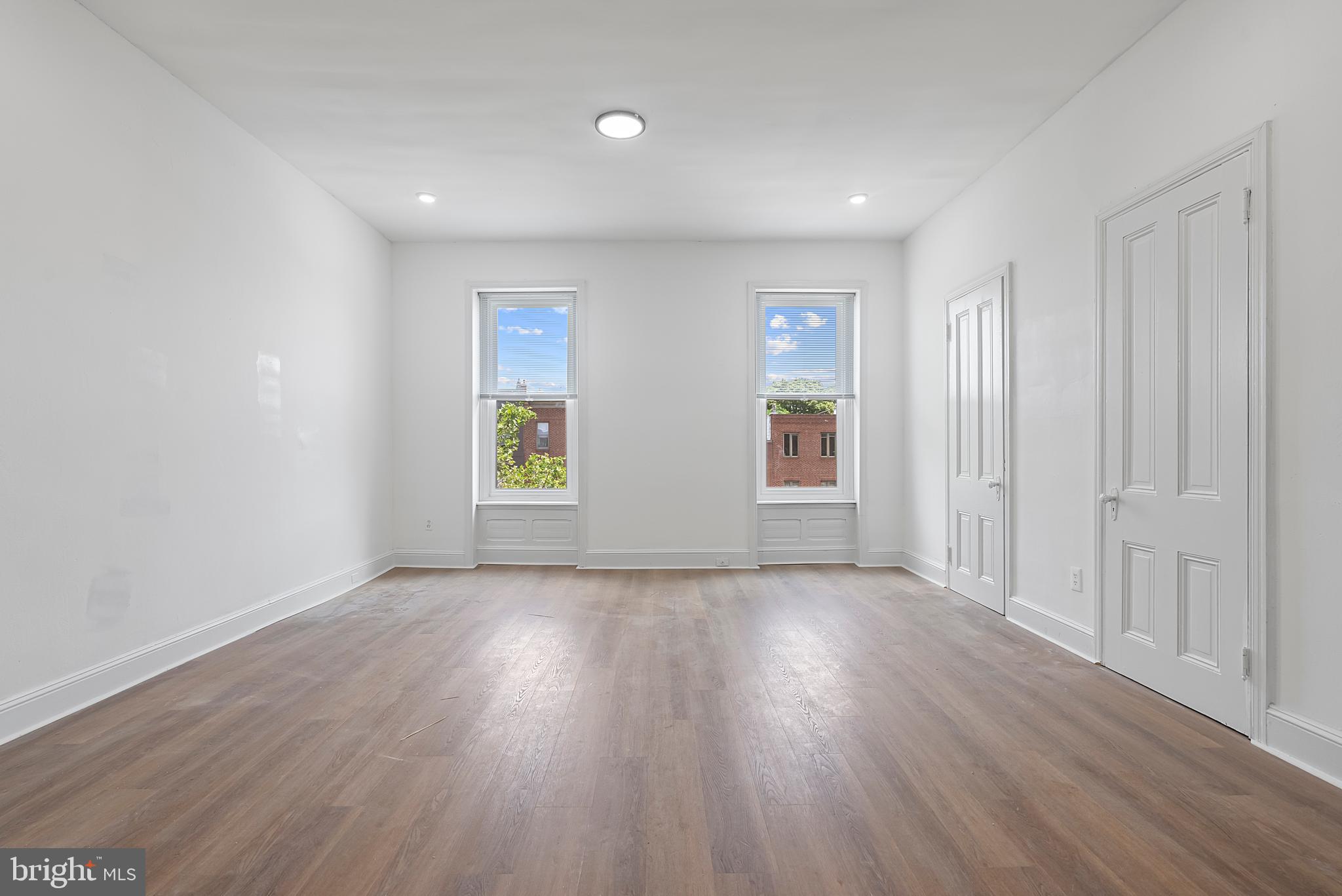 1618 South Broad Street Philadelphia, PA 19145 - Photo 19 of 27 an empty room with wooden floor and windows