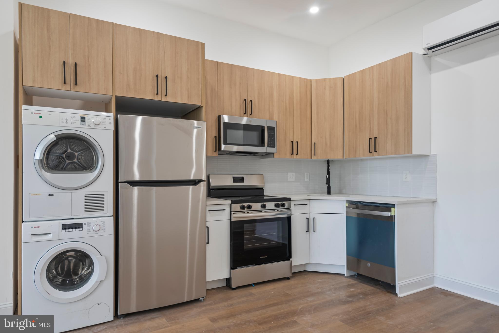 1618 South Broad Street Philadelphia, PA 19145 - Photo 20 of 27 a kitchen with stainless steel appliances granite countertop a refrigerator and a stove top oven