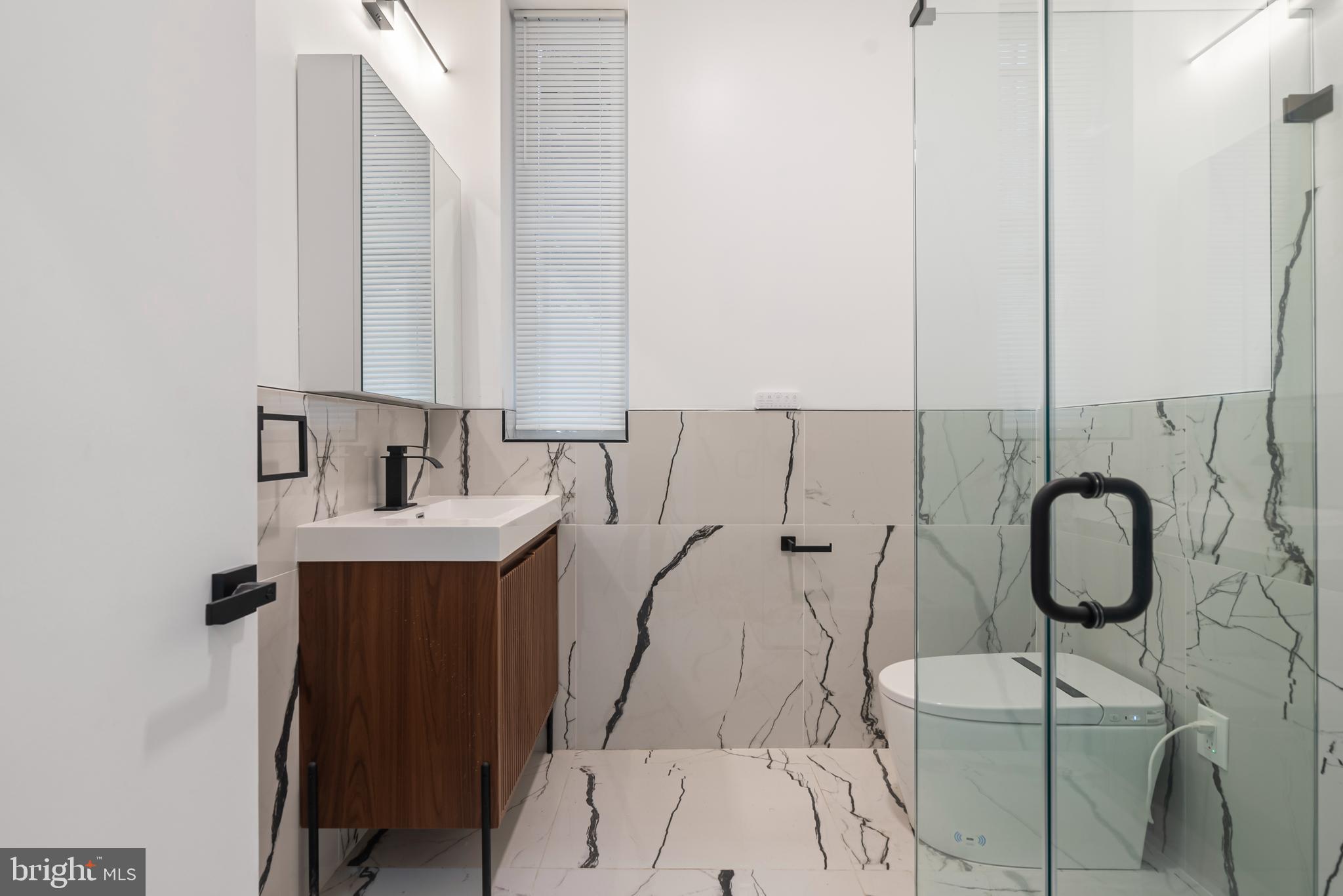 1618 South Broad Street Philadelphia, PA 19145 - Photo 5 of 27 a bathroom with a sink and a mirror
