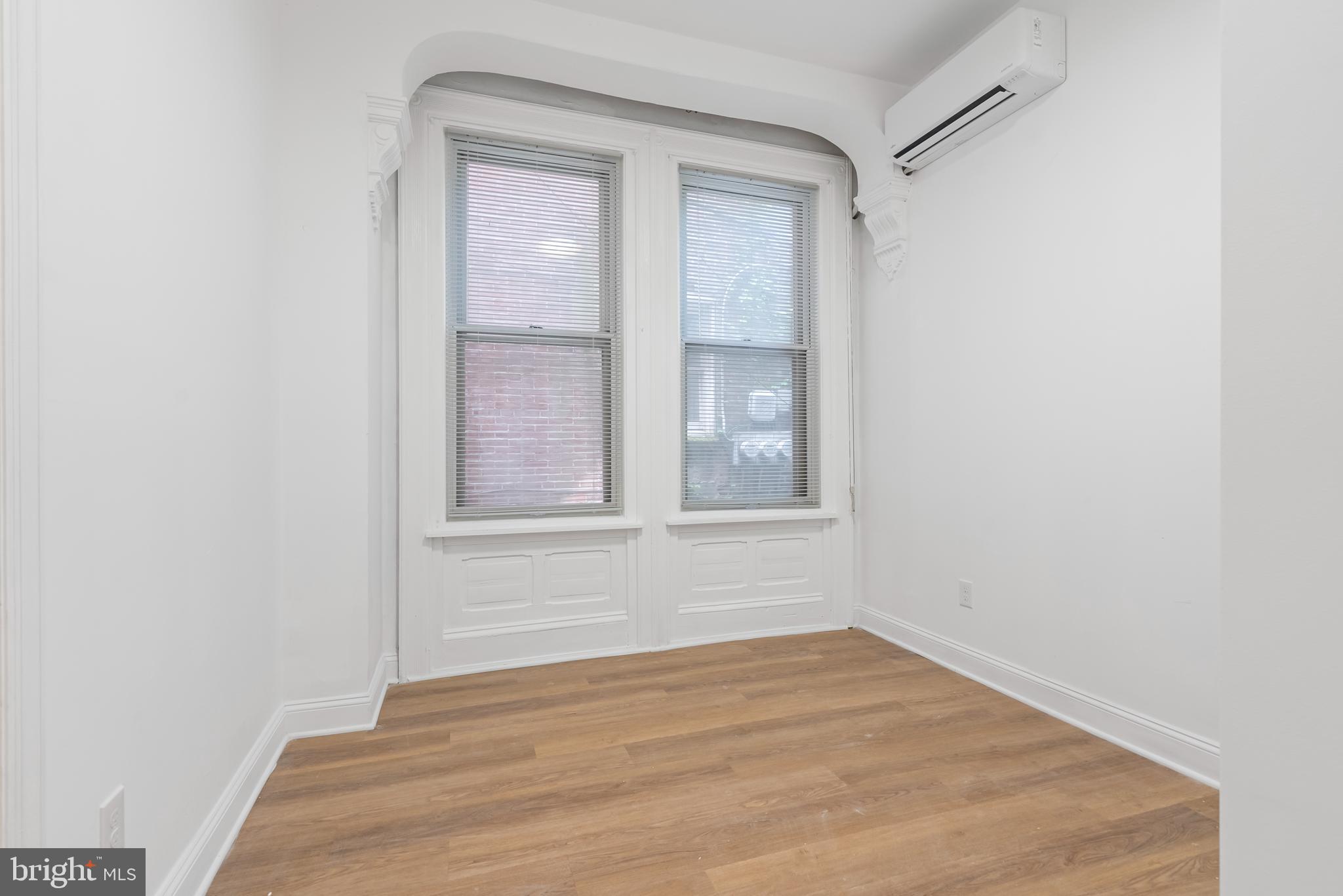 1618 South Broad Street Philadelphia, PA 19145 - Photo 6 of 27 a view of an empty room with wooden floor and a window
