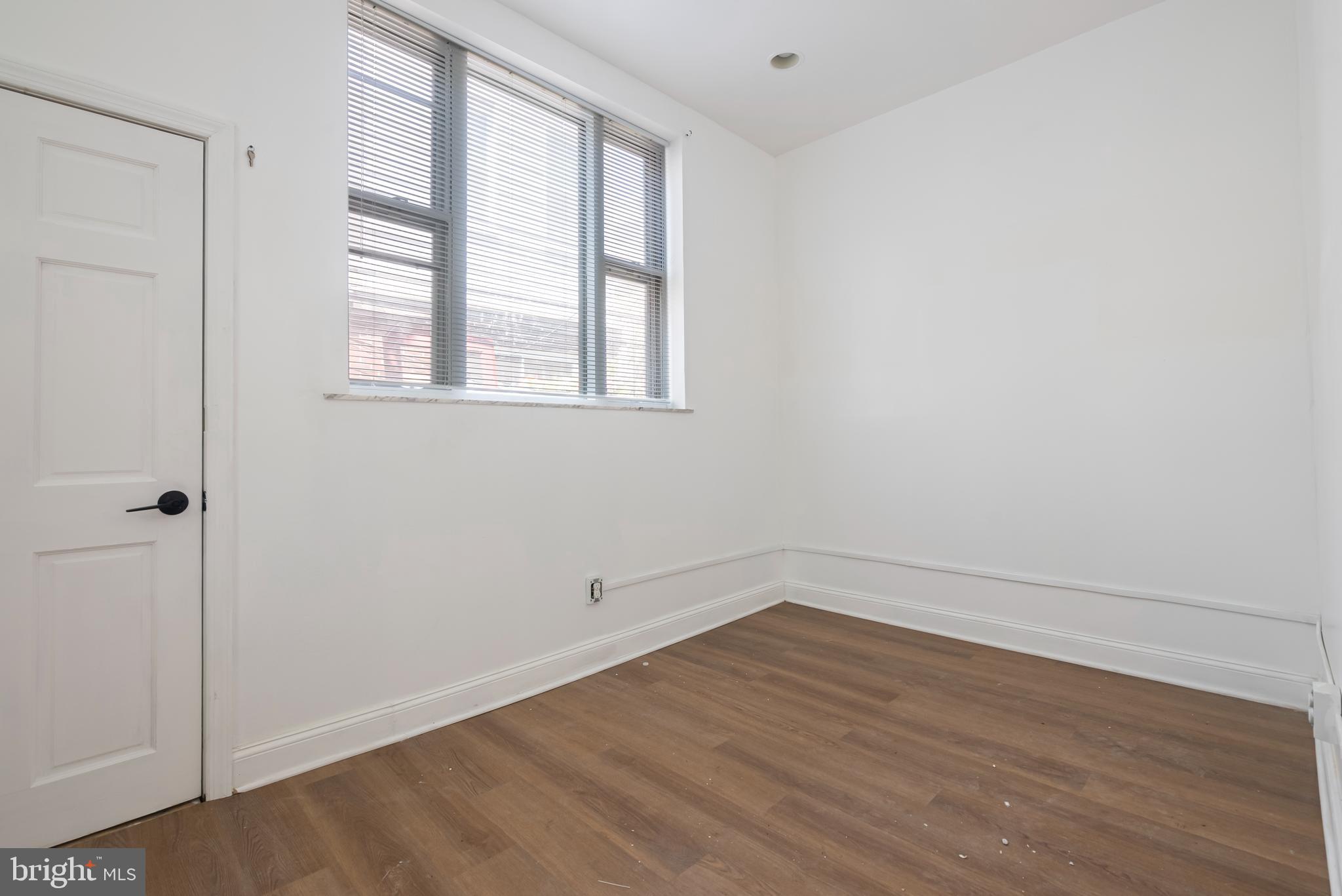 1618 South Broad Street Philadelphia, PA 19145 - Photo 9 of 27 wooden floor in an empty room with a window
