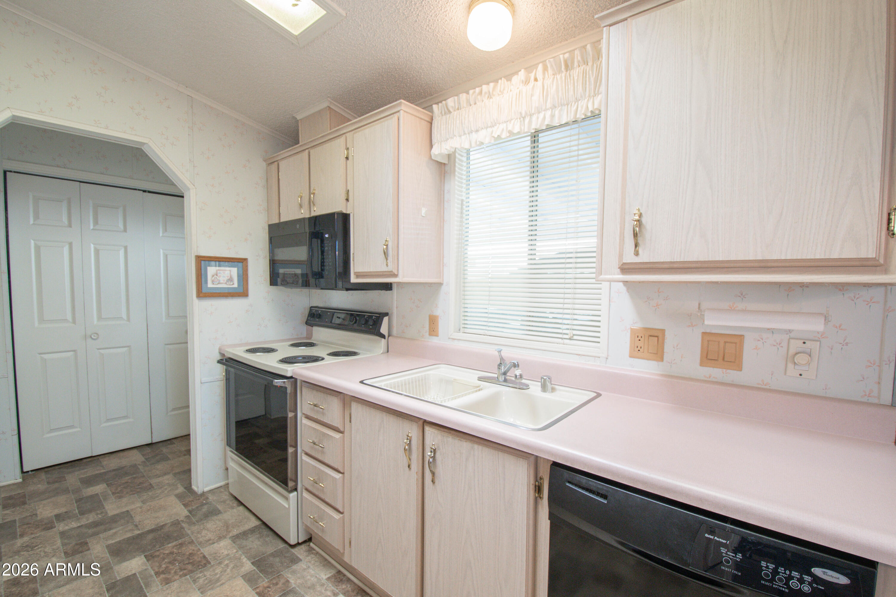 5735 East McDowell Road, Unit 26 Mesa, AZ 85215 - Photo 11 of 39 a kitchen with a sink stove and microwave