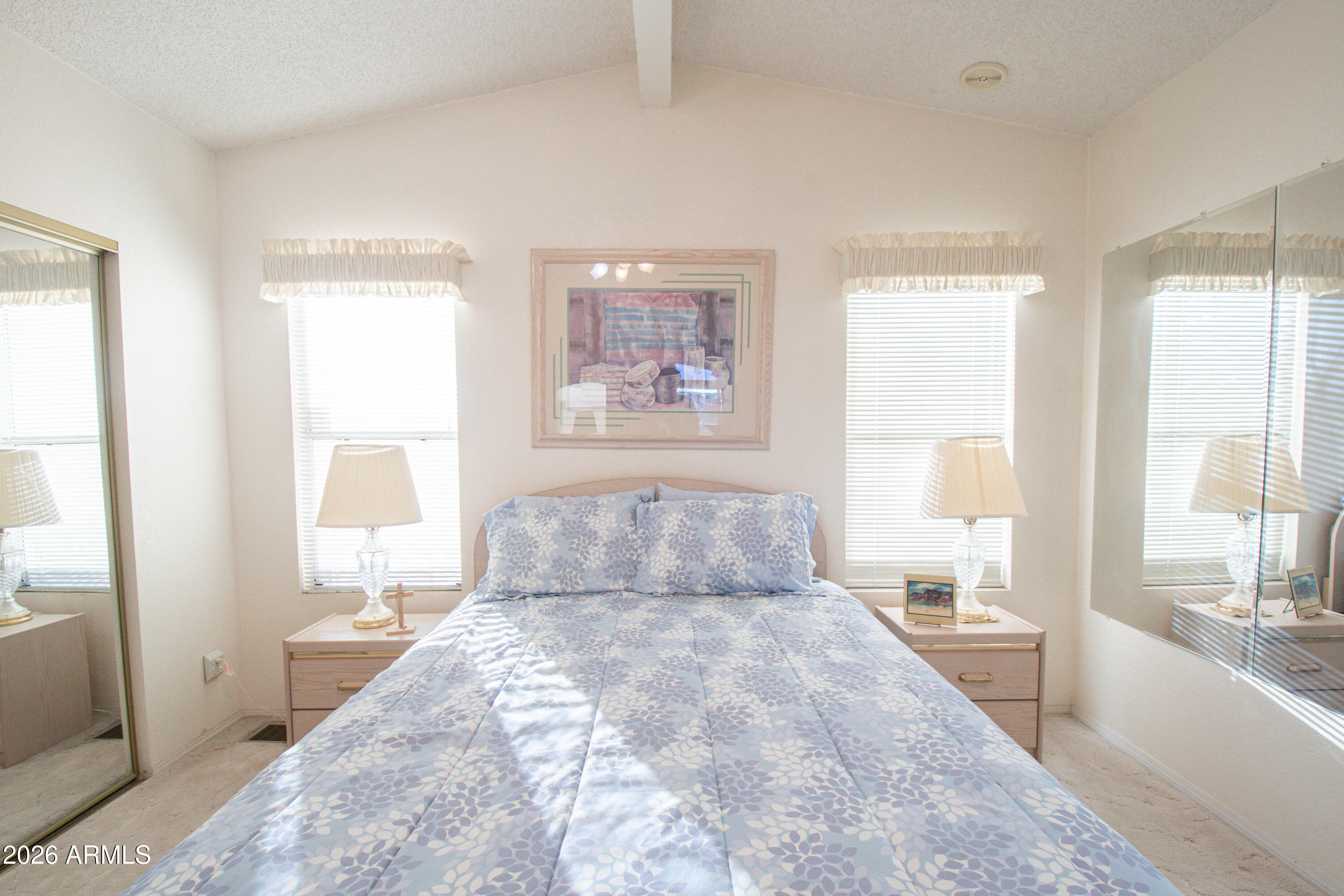 5735 East McDowell Road, Unit 26 Mesa, AZ 85215 - Photo 14 of 39 a spacious bedroom with a large bed and a large window