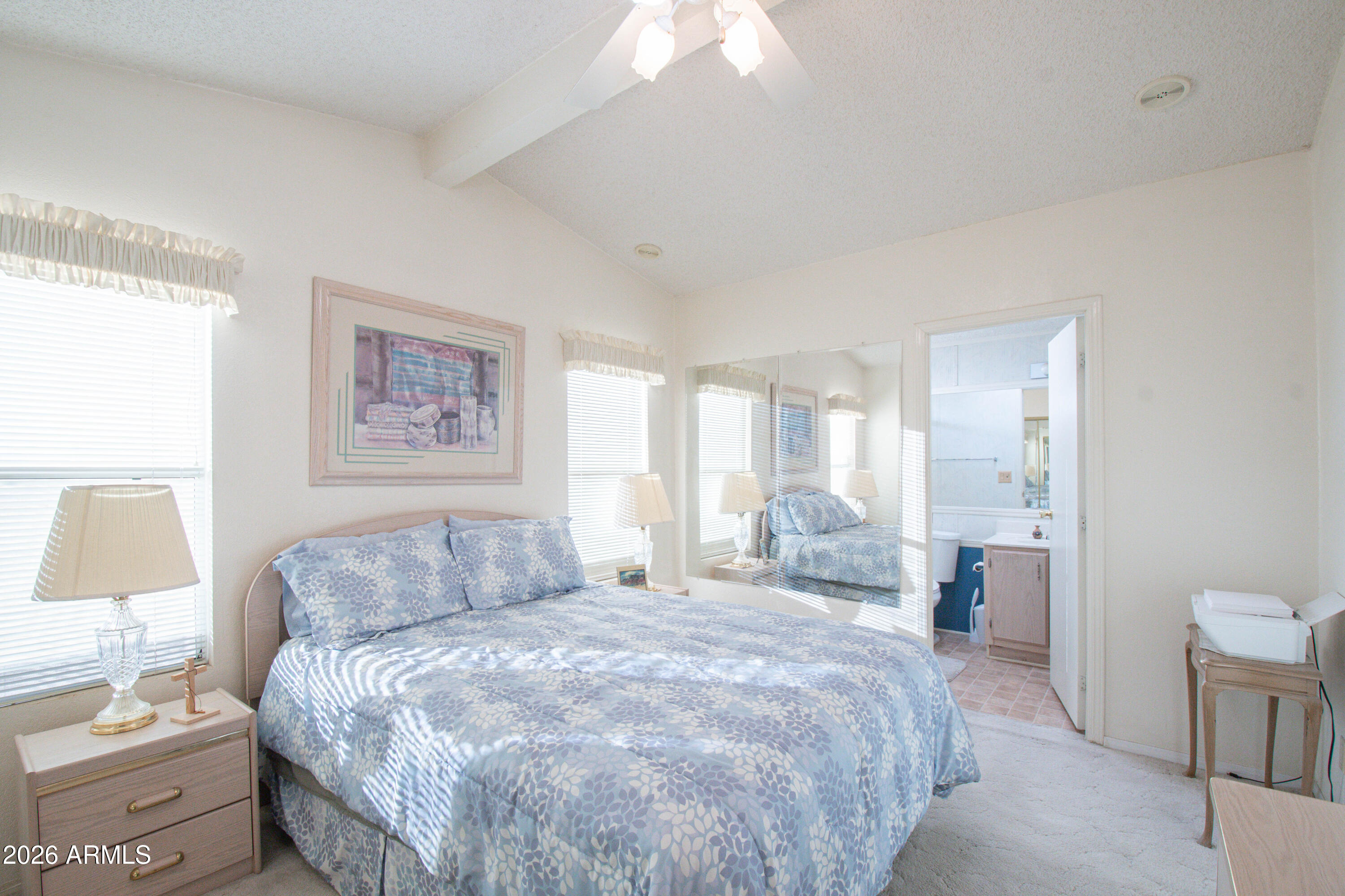 5735 East McDowell Road, Unit 26 Mesa, AZ 85215 - Photo 15 of 39 a bedroom with a bed and a painting on the wall