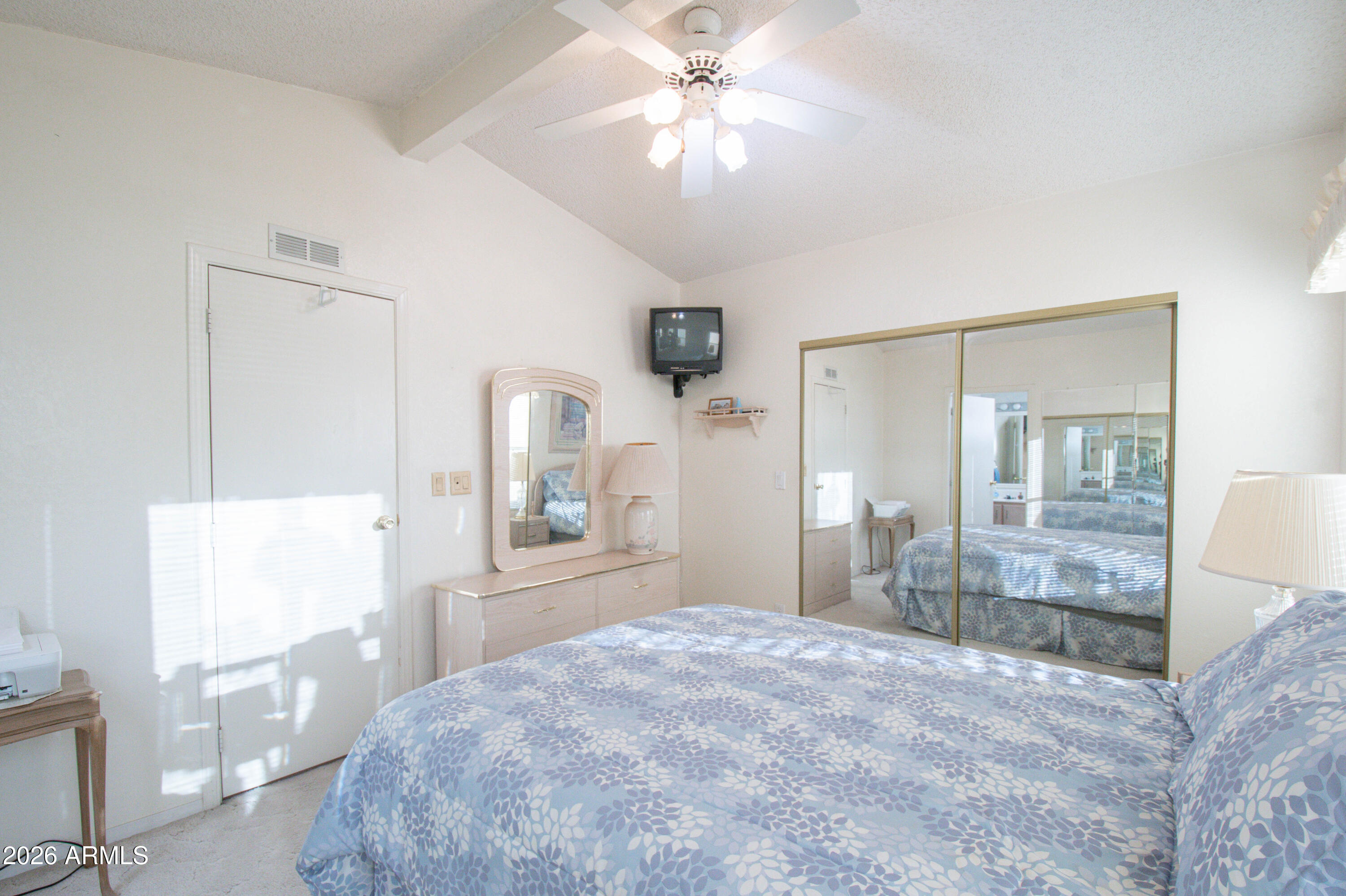 5735 East McDowell Road, Unit 26 Mesa, AZ 85215 - Photo 16 of 39 a bedroom with a bed and a chandelier