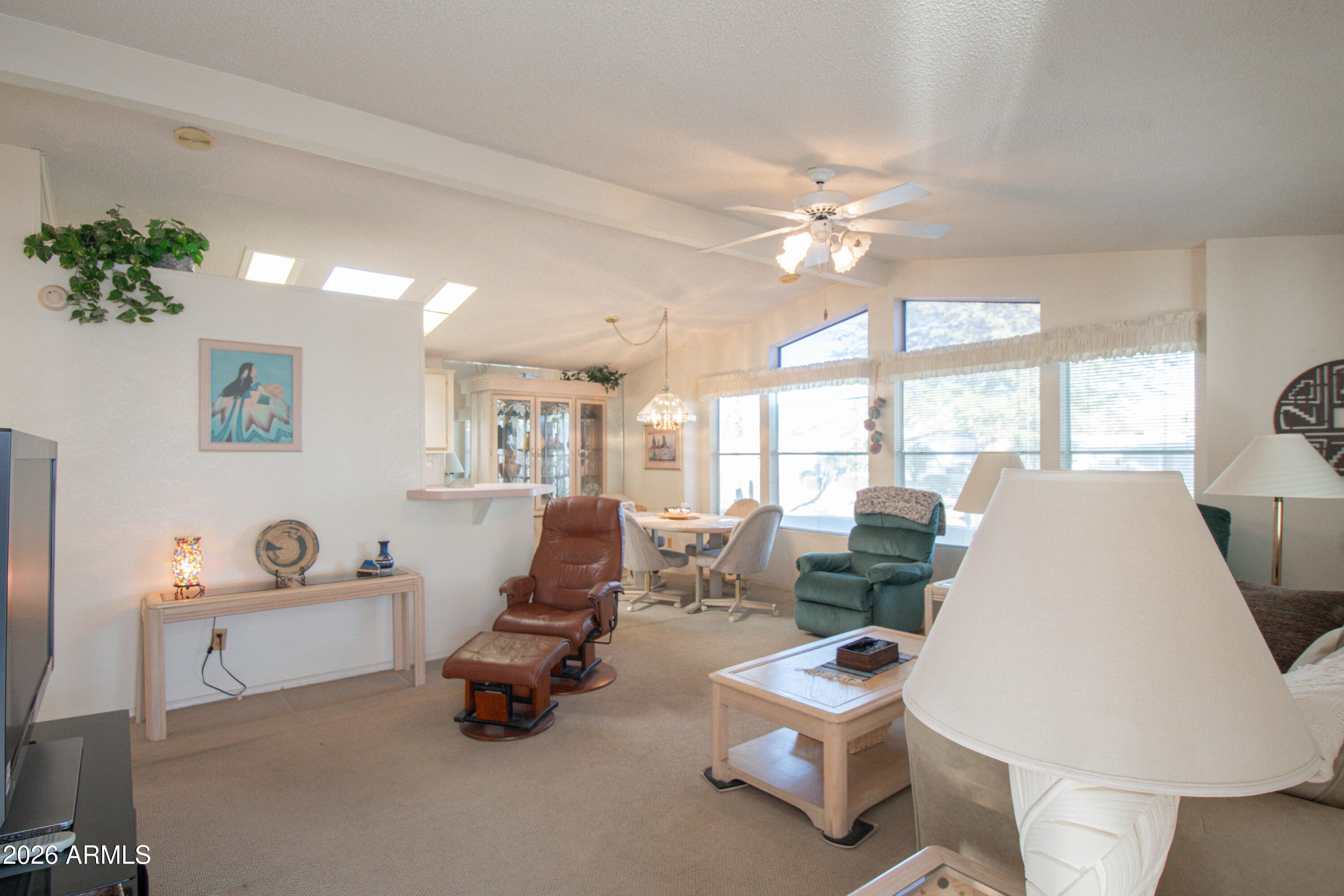 5735 East McDowell Road, Unit 26 Mesa, AZ 85215 - Photo 2 of 39 a living room with furniture and a large window
