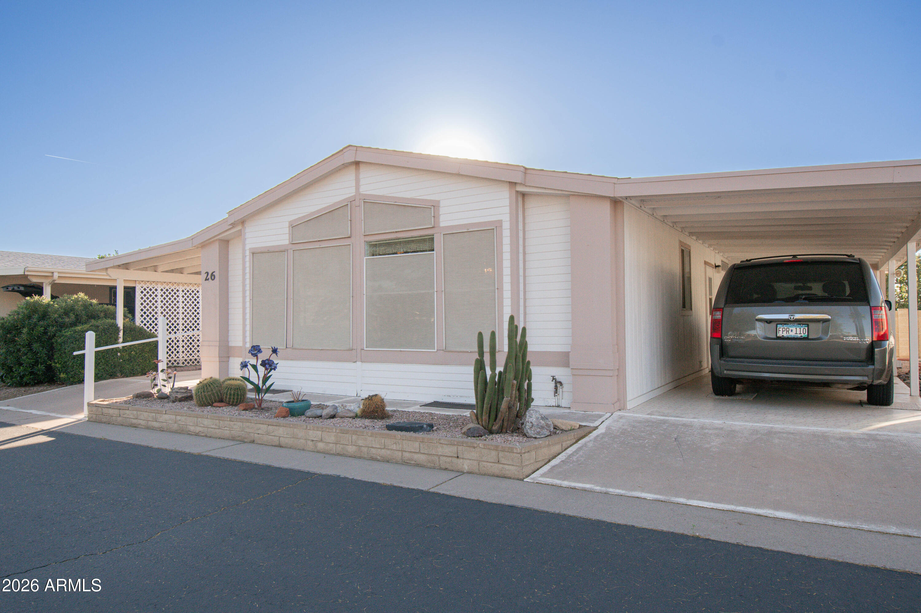 5735 East McDowell Road, Unit 26 Mesa, AZ 85215 - Photo 21 of 39 a view of a car garage door and a car parked in garage