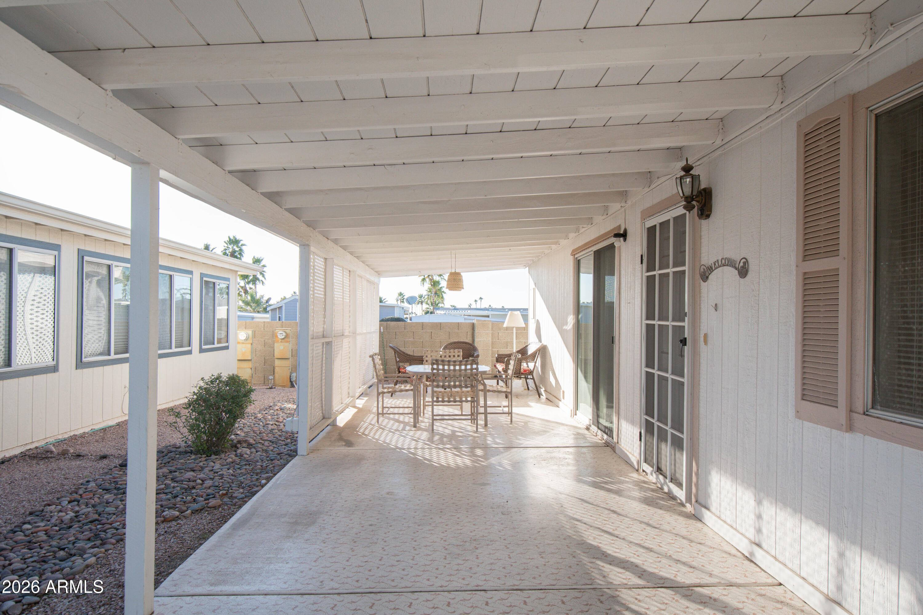 5735 East McDowell Road, Unit 26 Mesa, AZ 85215 - Photo 25 of 39 a view of a patio with table and chairs and potted plants