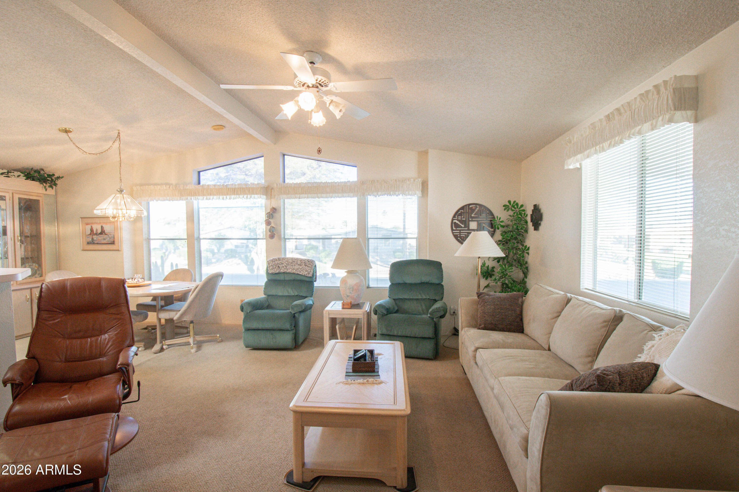 5735 East McDowell Road, Unit 26 Mesa, AZ 85215 - Photo 3 of 39 a living room with furniture and floor to ceiling windows