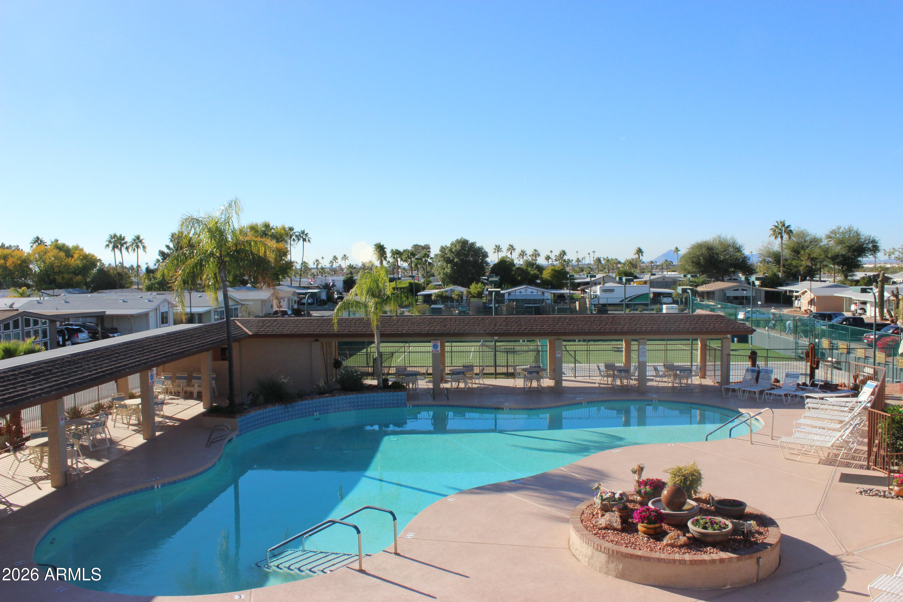 5735 East McDowell Road, Unit 26 Mesa, AZ 85215 - Photo 32 of 39 a view of a swimming pool with a table and a chairs