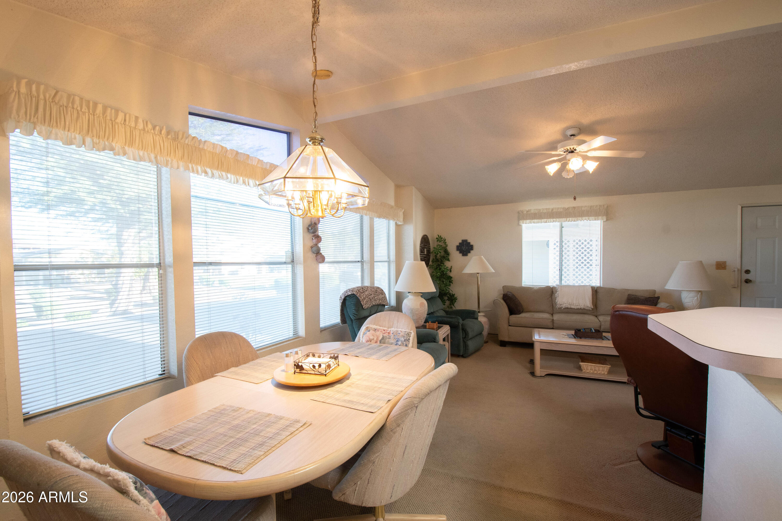 5735 East McDowell Road, Unit 26 Mesa, AZ 85215 - Photo 8 of 39 a living room with furniture a window and a dining table