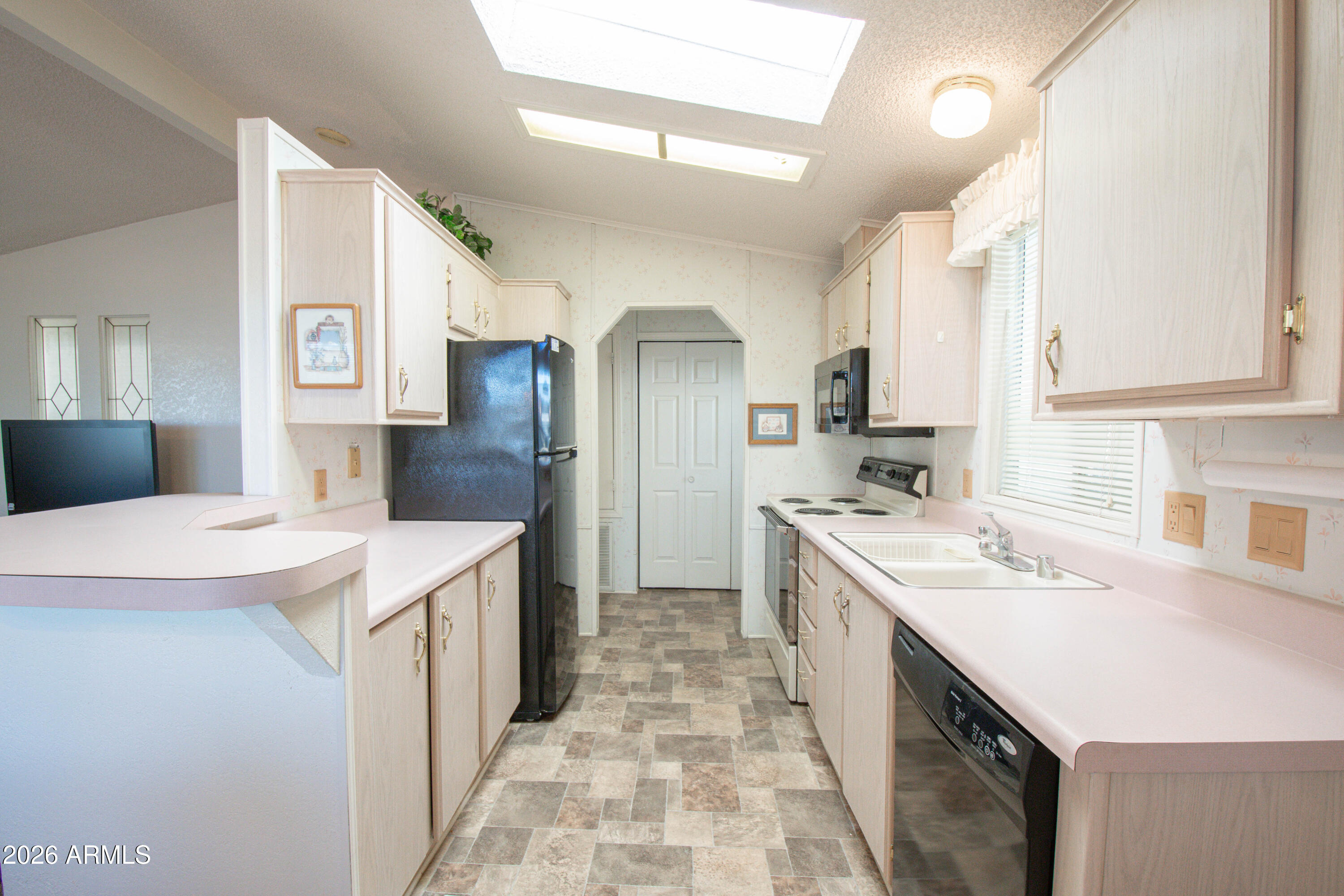 5735 East McDowell Road, Unit 26 Mesa, AZ 85215 - Photo 9 of 39 a kitchen with a sink stove and refrigerator