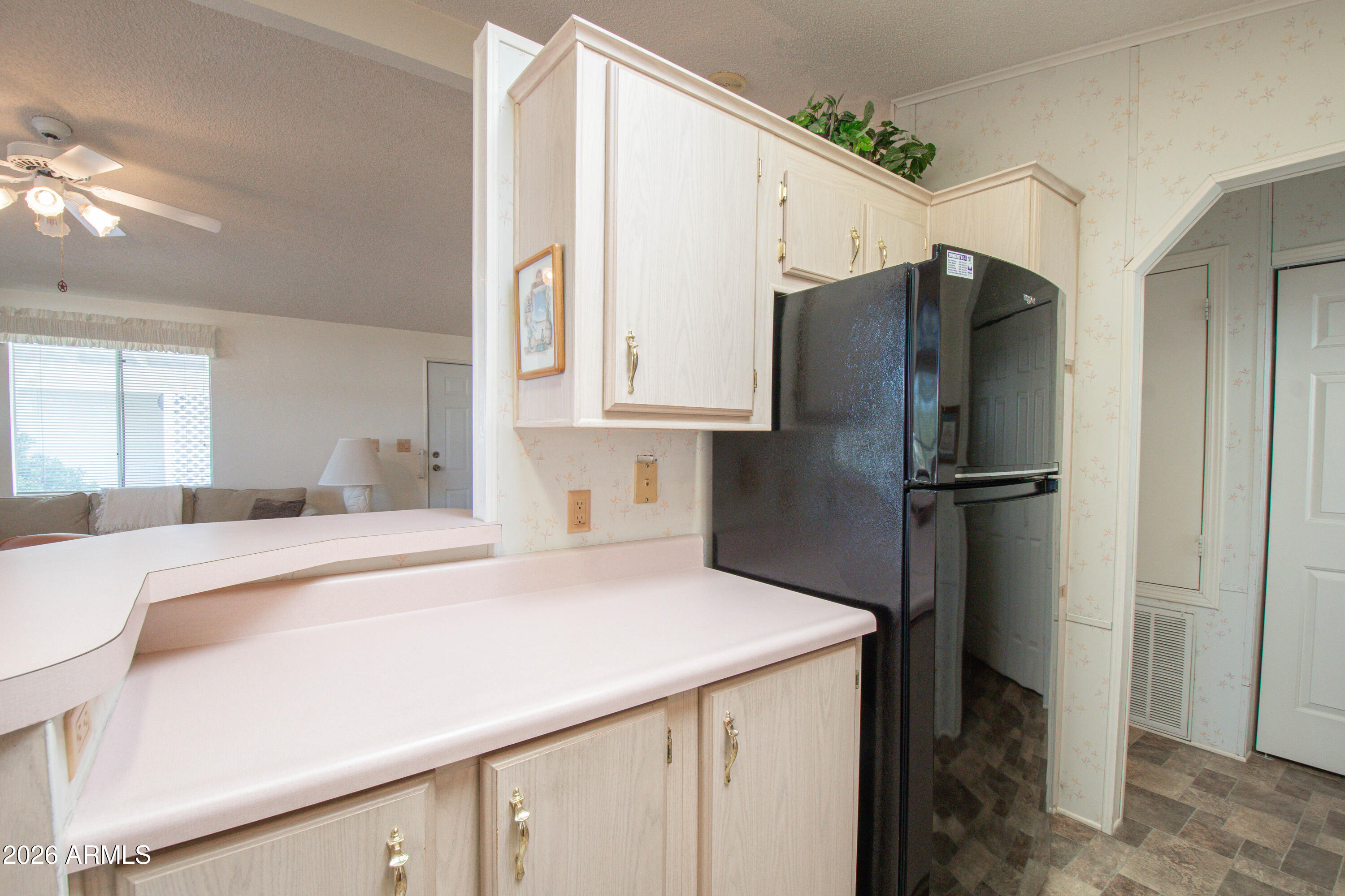 5735 East McDowell Road, Unit 26 Mesa, AZ 85215 - Photo 10 of 39 a kitchen with stainless steel appliances a refrigerator sink and cabinets