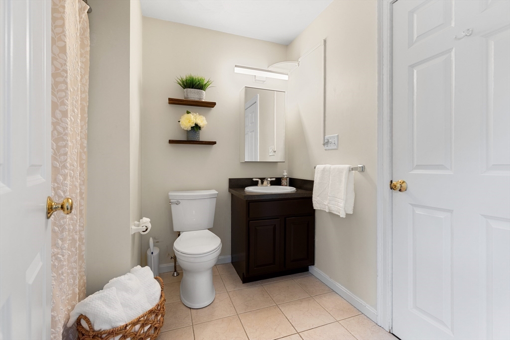 2 Ricciuti Drive, Unit 9 Quincy, MA 02169 - Photo 24 of 40 a bathroom with a toilet and a shower