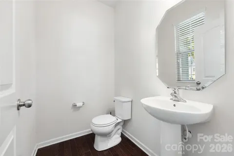 a bathroom with a sink toilet and mirror