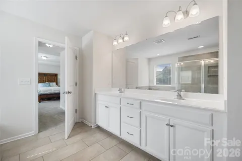 a bathroom with a sink vanity and a mirror