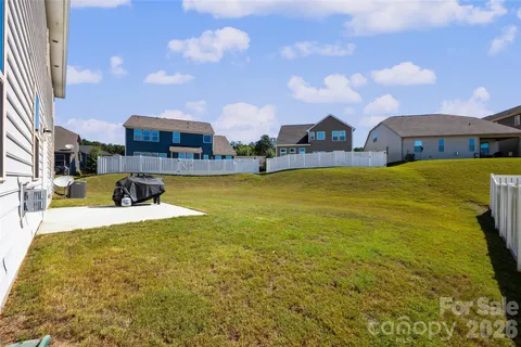 a view of a house with a swimming pool and a yard