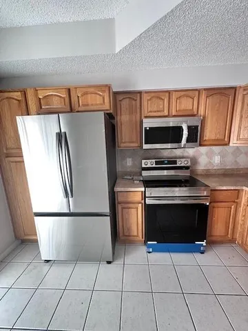 a kitchen with cabinets and steel stainless steel appliances
