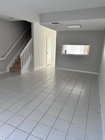 a view of an empty room and stairs