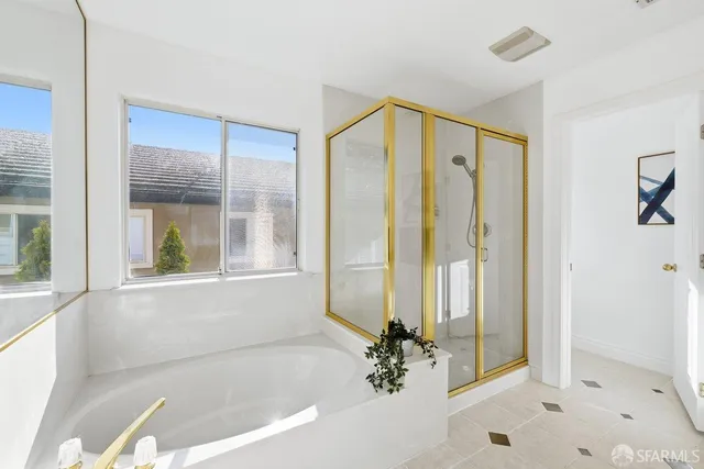 a bathroom with a bathtub and a shower