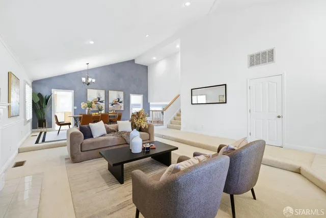 a living room with furniture and a large mirror