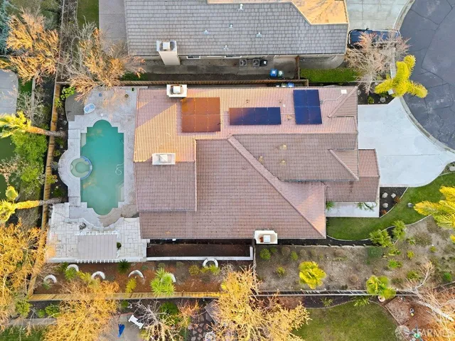 an aerial view of a house with swimming pool and patio