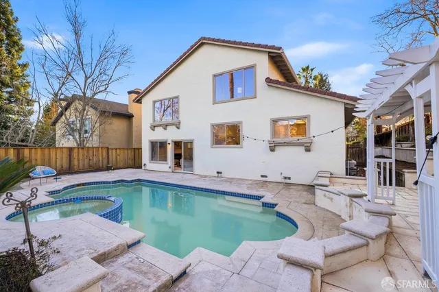 a swimming pool with outdoor seating