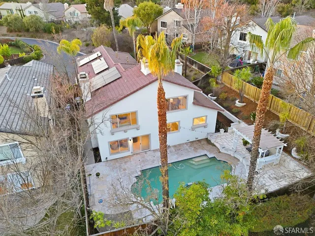 an aerial view of multiple houses with yard