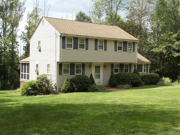 39 Barton Road Stow, MA 01775 - Photo 1 of 14 a front view of a house with a yard and green space