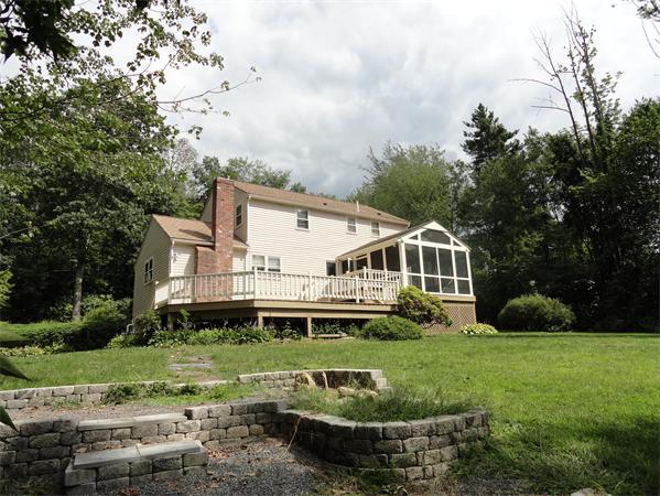 39 Barton Road Stow, MA 01775 - Photo 3 of 14 a front view of a house with a yard