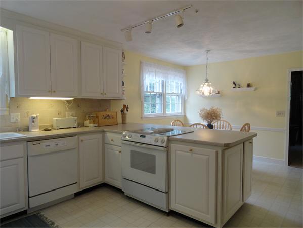 39 Barton Road Stow, MA 01775 - Photo 7 of 14 a kitchen with stainless steel appliances granite countertop a sink and a stove