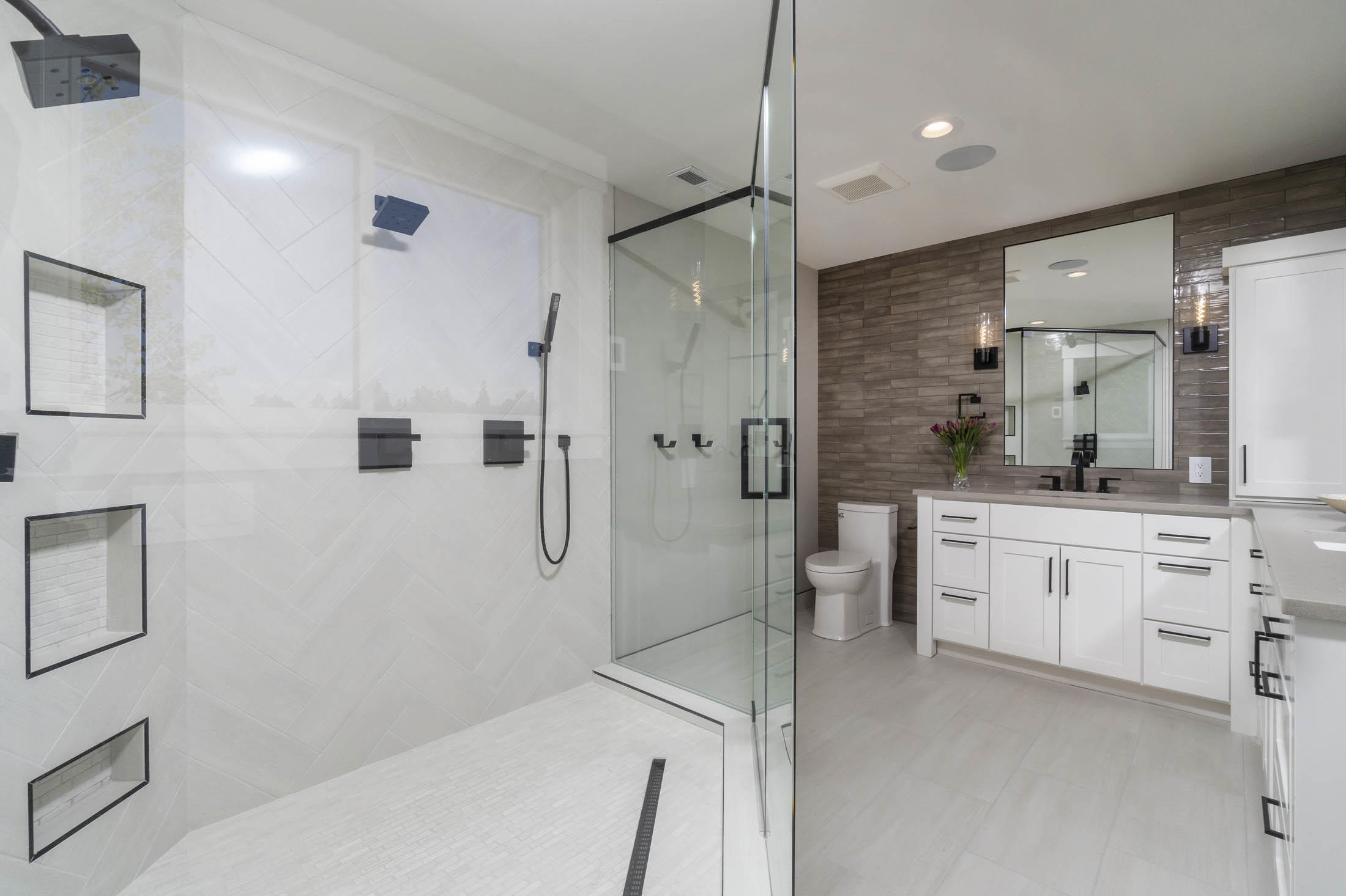 64486 McGrath Road Bend, OR 97701 - Photo 18 of 38 Primary bathroom with tile walk-in shower including custom glass enclosure, dual shower heads and hand sprayer, heated tile floor.