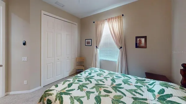 a kitchen with stainless steel appliances kitchen island granite countertop a refrigerator a stove a kitchen island with chairs and wooden floor