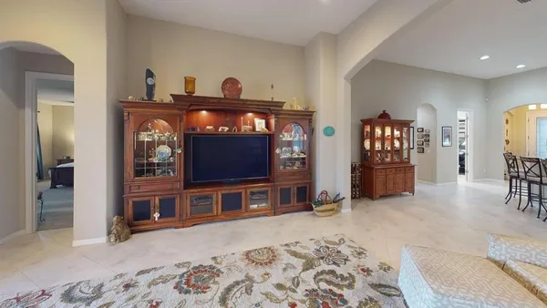 a living room with furniture and a book shelf