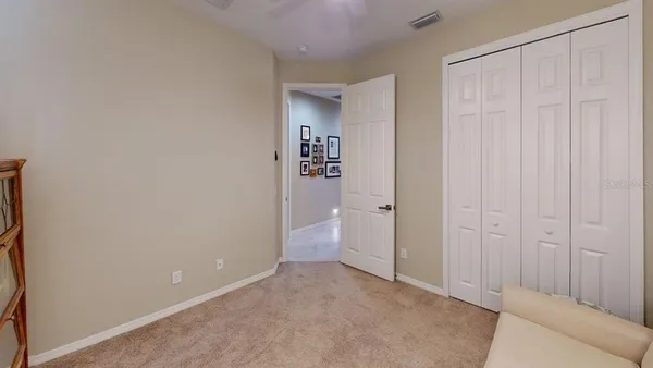 a view of a livingroom with workspace and a window