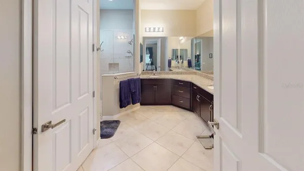 a work room with furniture a bookshelf and a window