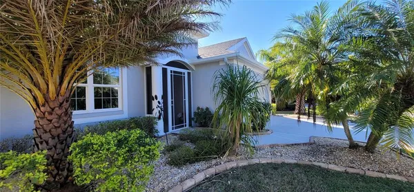 a view of a house with a tree in front of it
