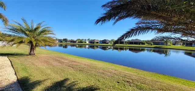 a view of a lake with houses in the back