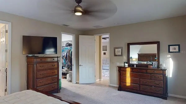 a view of walk in closet with clothes and shoes