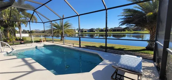 a bedroom with a bed and a flat tv screen on dresser